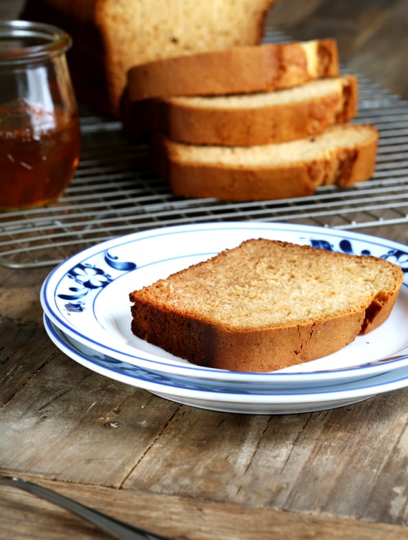 A piece of honey bread on a white plate