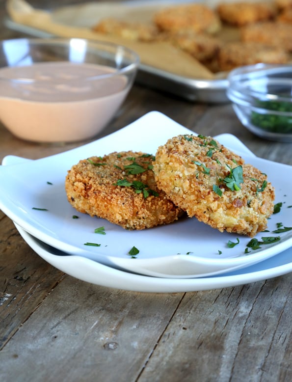 2 cauliflower fritters on white plate