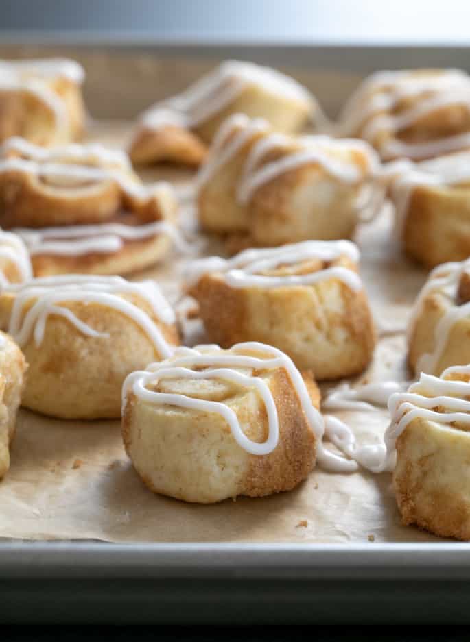 Cinnamon roll sugar cookies, drizzled with icing closeup image