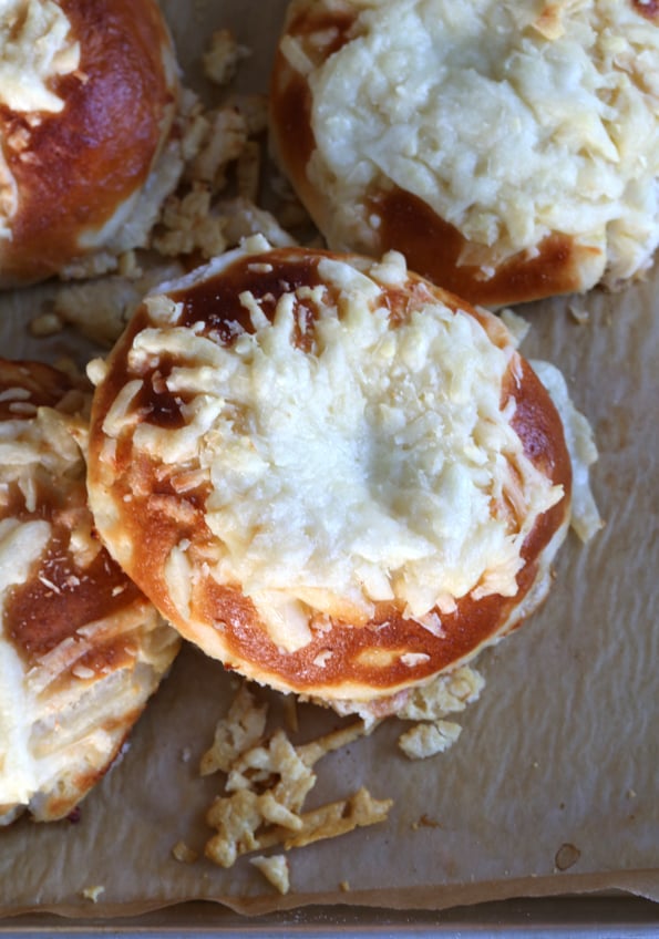 Overhead view of bagel on brown surface 