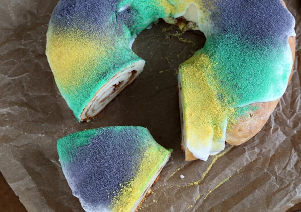 Overhead view of king cake on brown surface 