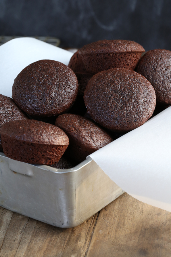 A box with white paper and two bite brownies