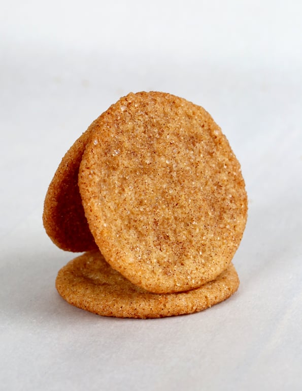 Snickerdoodle cookies leaning against each other in white surface