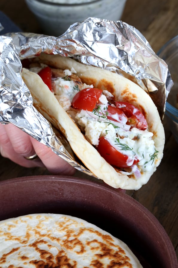 Person holding chicken gyros