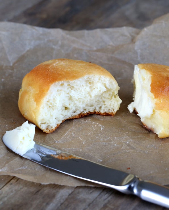 A half eaten piece of gluten free Texas roadhouse rolls.