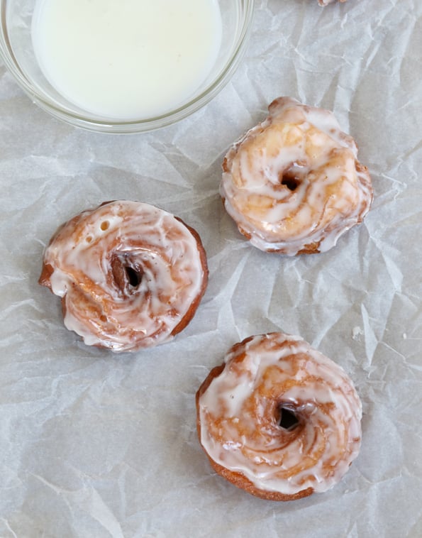 Overhead view of donuts on white surface 