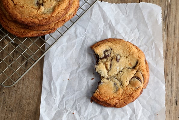 Overhead image of one cookie on a wire rack and another broken cookie on white paper