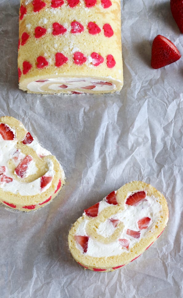 Overhead view of Strawberry Cake Roll on white surface 