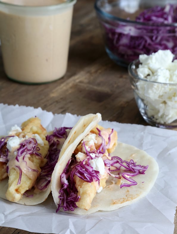 2 baja fish tacos on a white surface