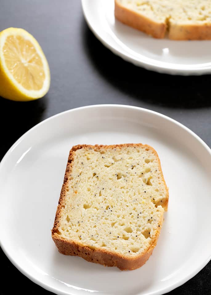 Plated gluten free lemon poppyseed bread showing moist and tender crumb inside and crisp-tender crust.