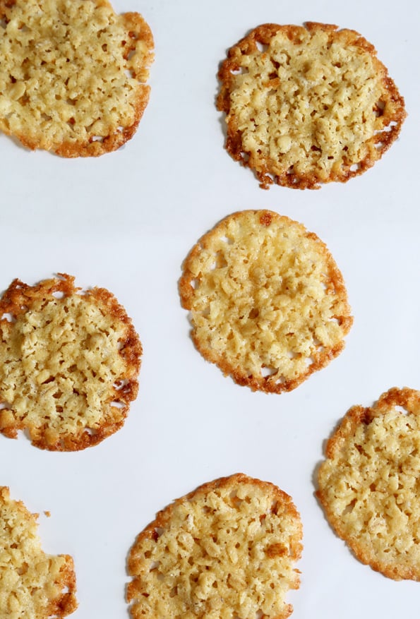 Overhead view of oatmeal lace cookies on white surface 