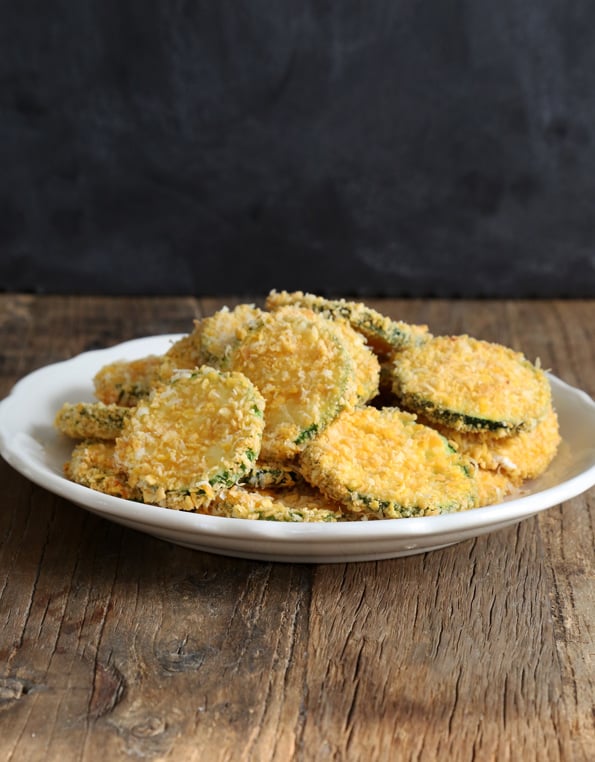 Zucchini with bread crumbs on a white plate 