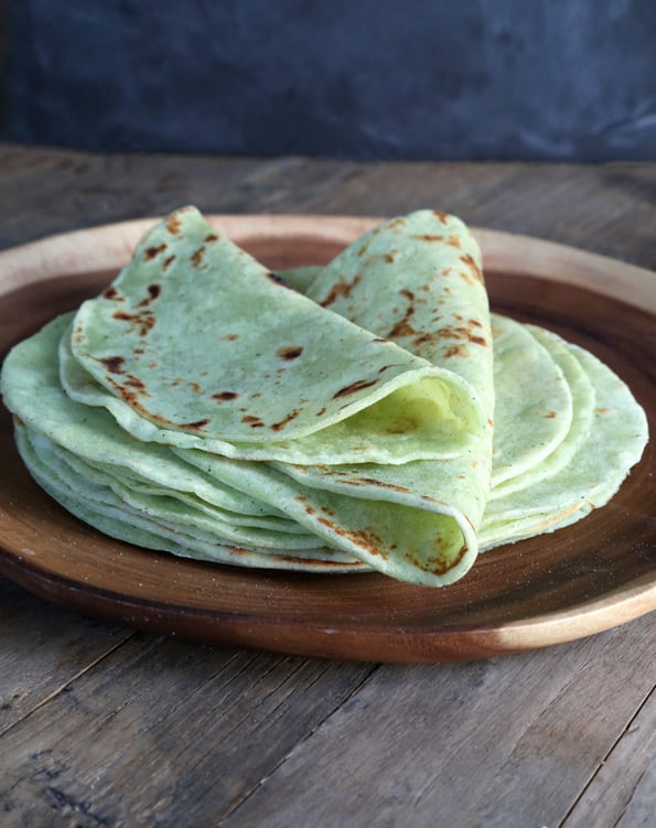 A stack of zucchini flour tortillas on brown plate 