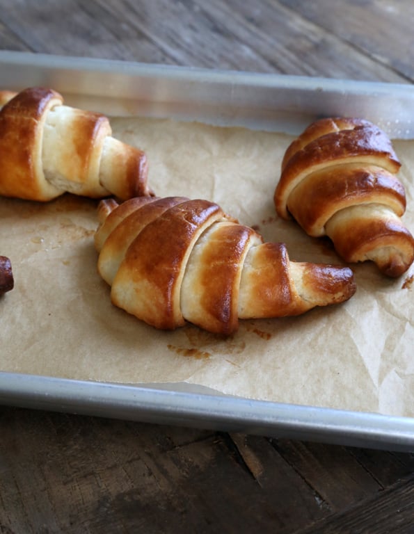 A close up of croissants on brown surface 