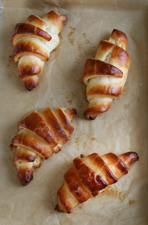 An overhead view of croissants on brown paper