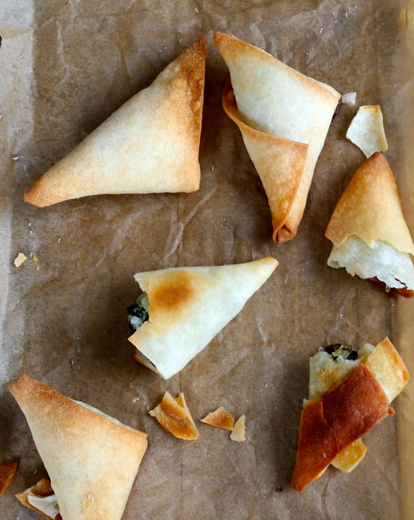 Overhead view of spanakopita on beige surface