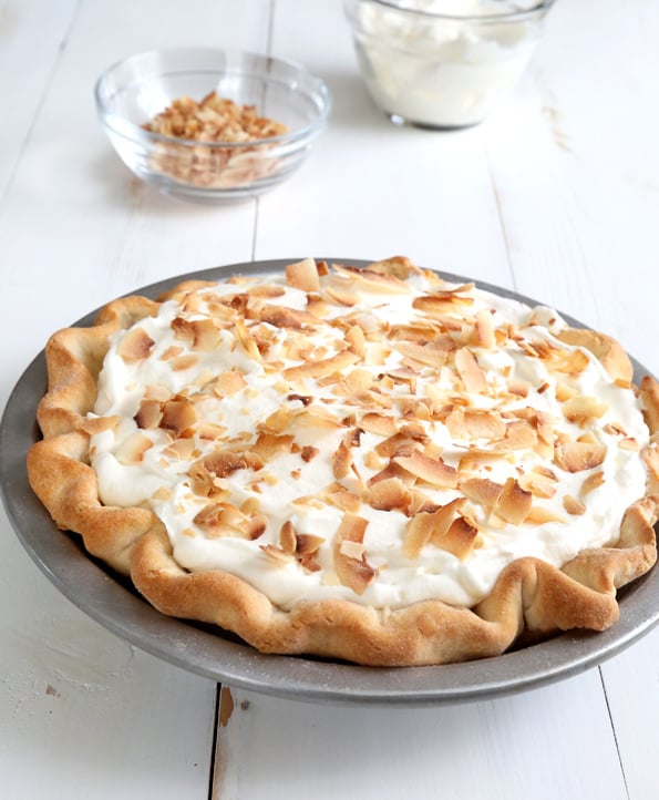 A coconut cream pie whole in a pie plate