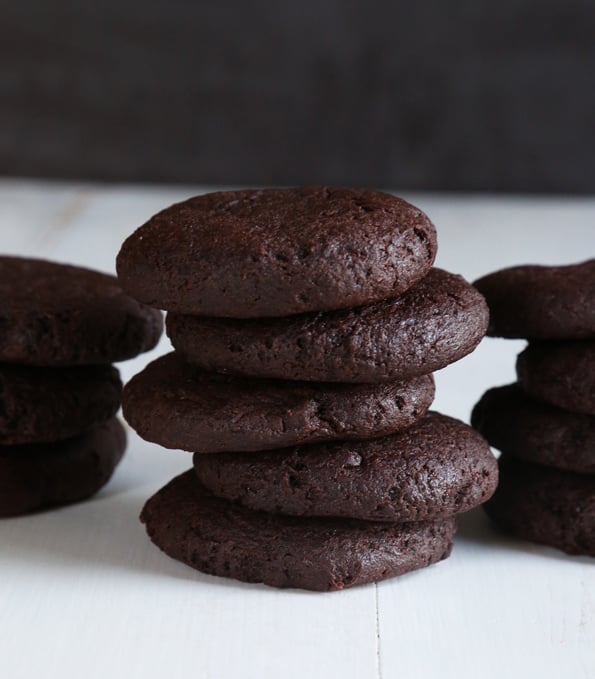 Stack of chocolate cheesecake cookies on white surface 