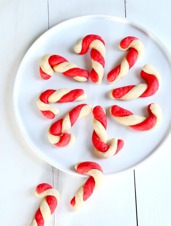 Overhead view of candy cane sugar cookies on white plate