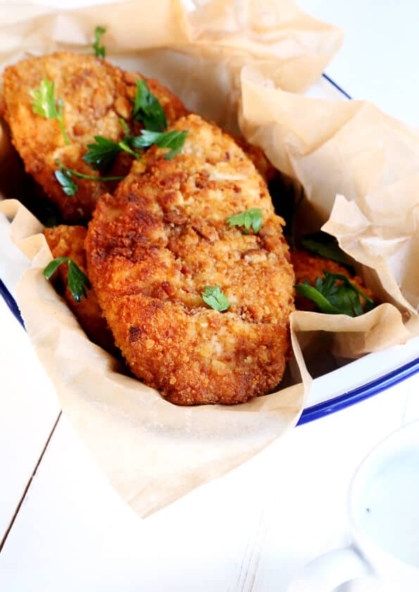 Fried chicken with herbs in a white dish