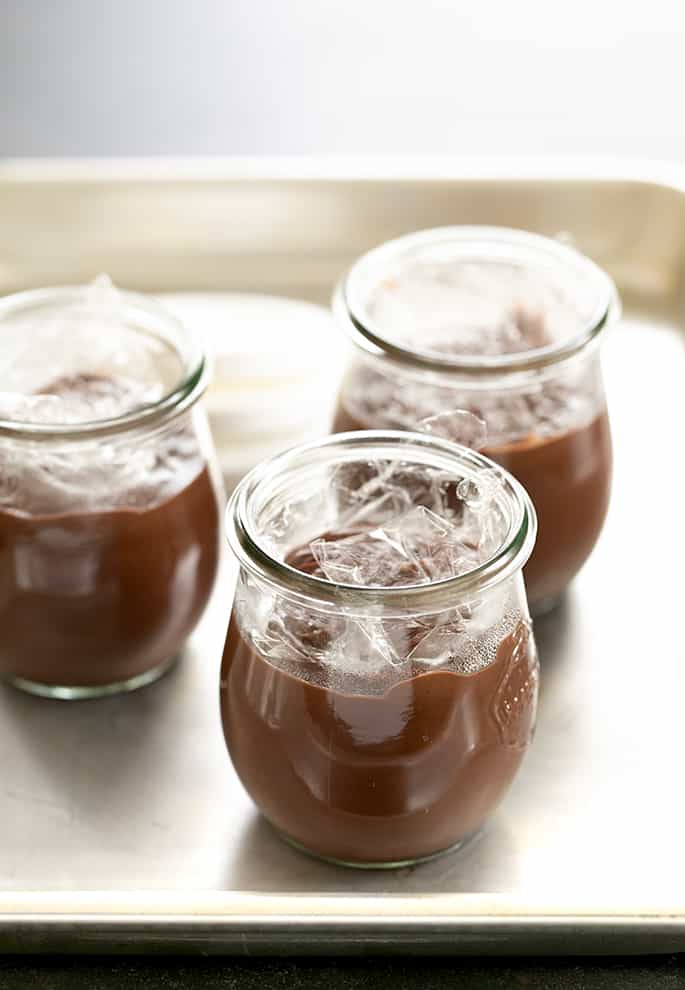 Chocolate pudding in jars with plastic wrap