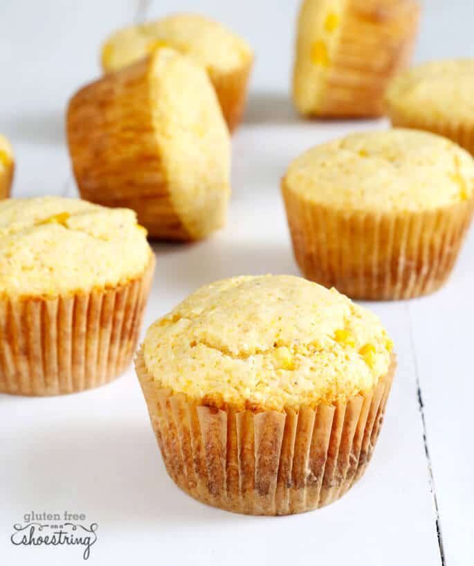 A close up of corn muffins on white surface