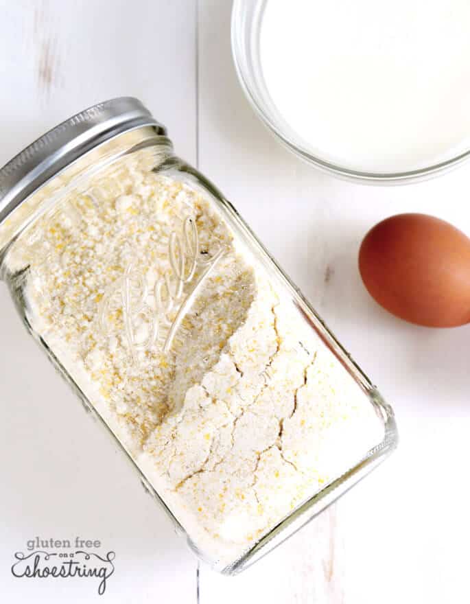 Corn muffin mix in a jar on white surface