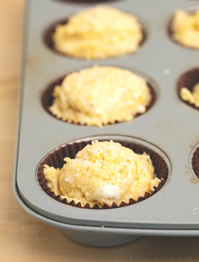 Raw corn muffin batter in muffin wells