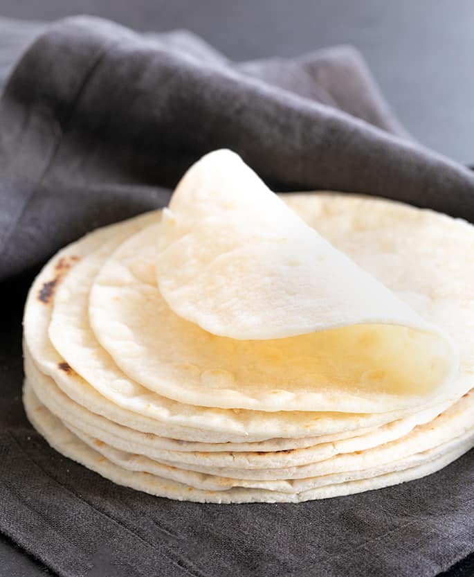 A stack of Paleo tortillas in a cloth with one folded over