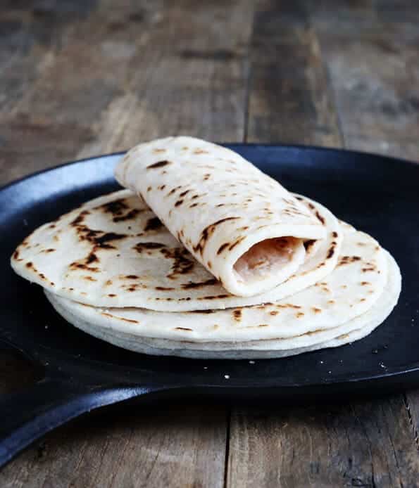 A stack of thicker Paleo tortillas in a skillet, from the side