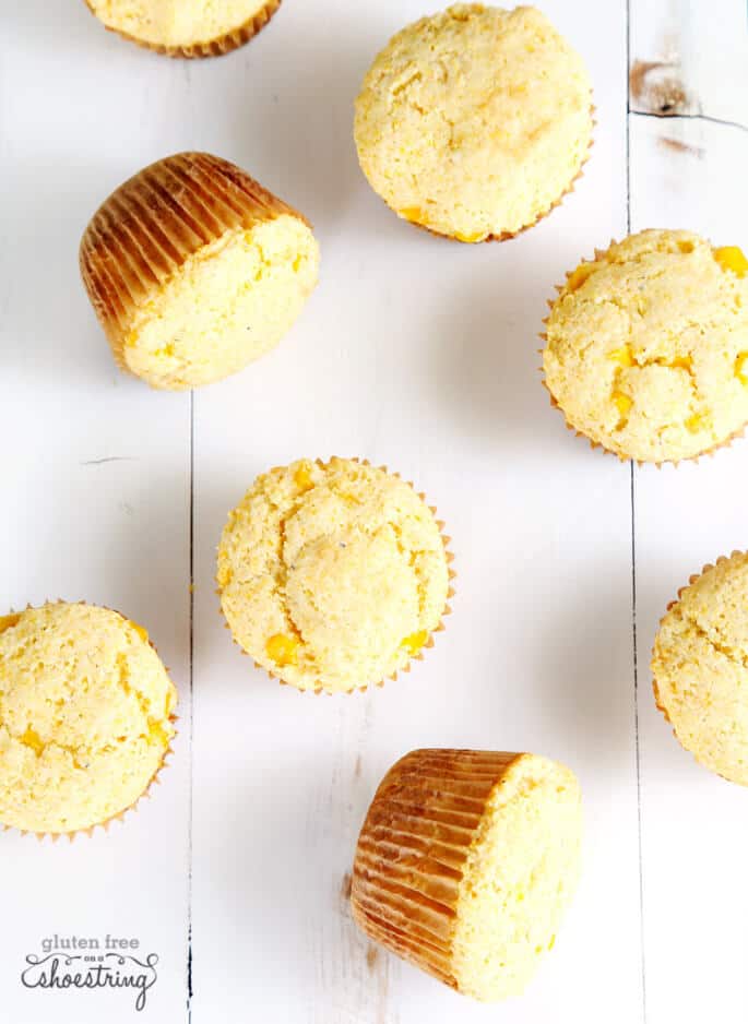 An overhead view of corn muffins on white surface 