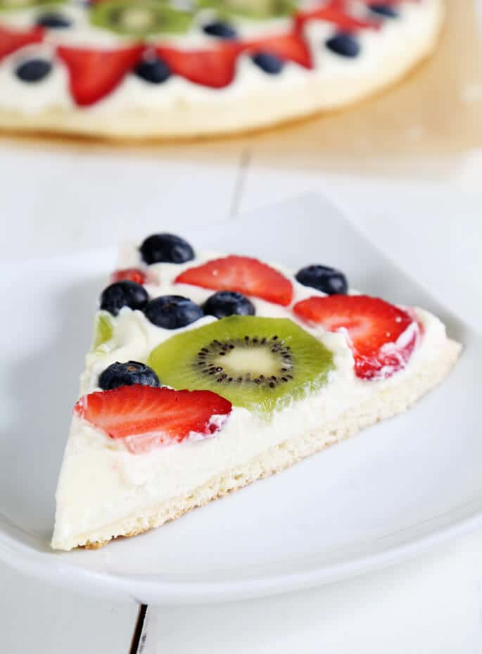 A close up of a slice of fruit cake on a white plate