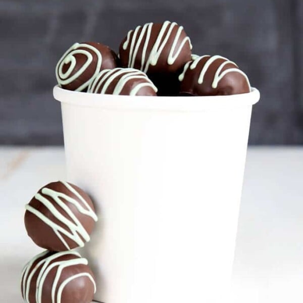 White jar with cookie dough truffles tin white surface