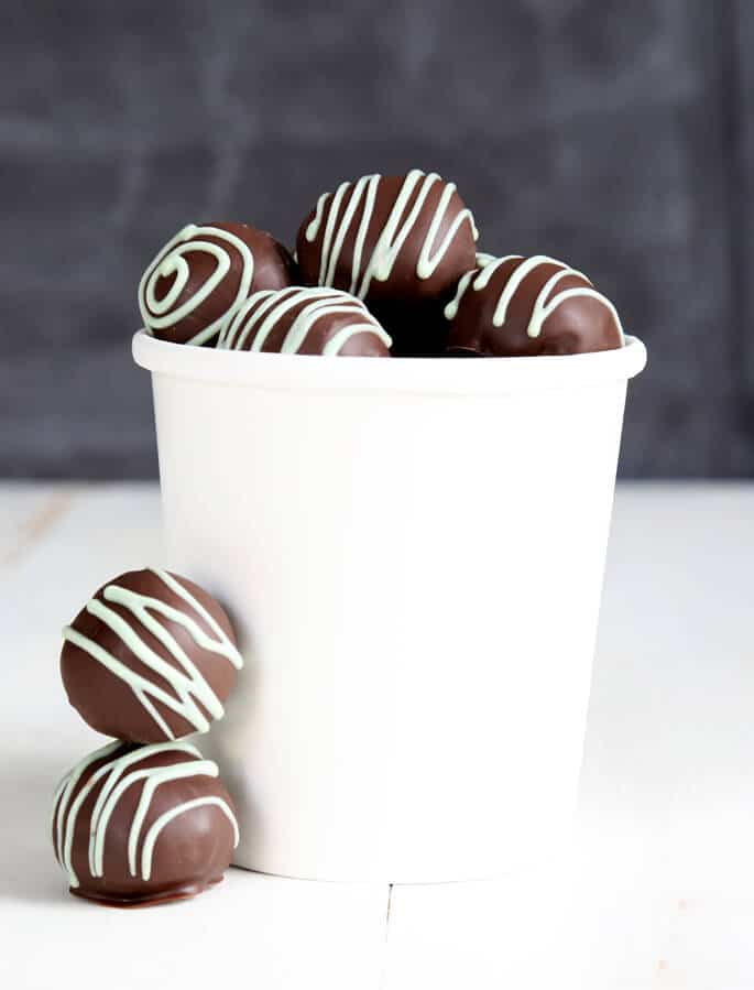 White jar with cookie dough truffles tin white surface 