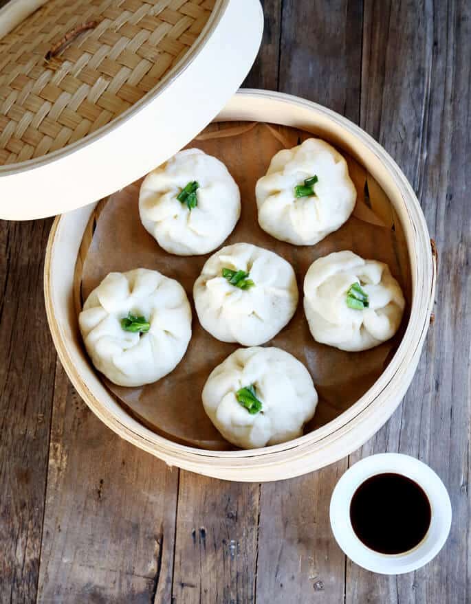 Overhead view of gluten free bao buns in bamboo steamer 