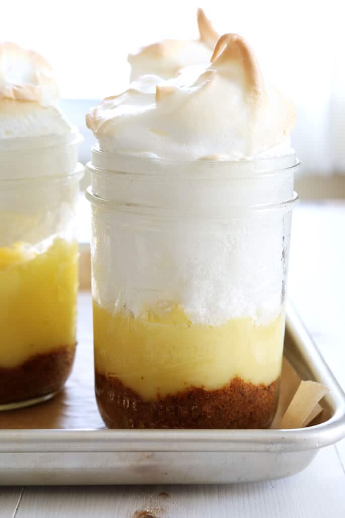 Lemon meringue pien in a jar on a metal tray