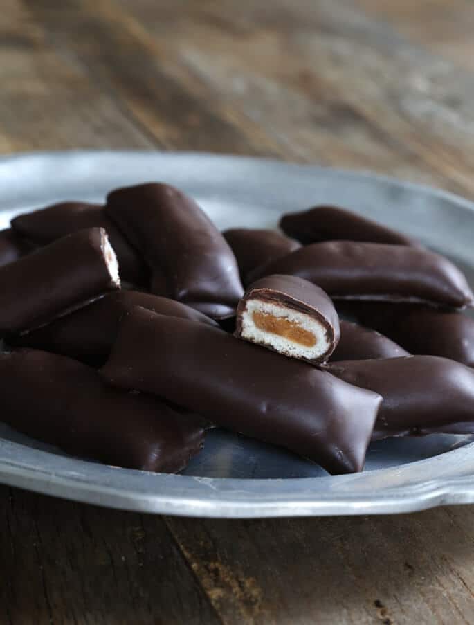 A close up of peanut butter crunch bars on metal plate