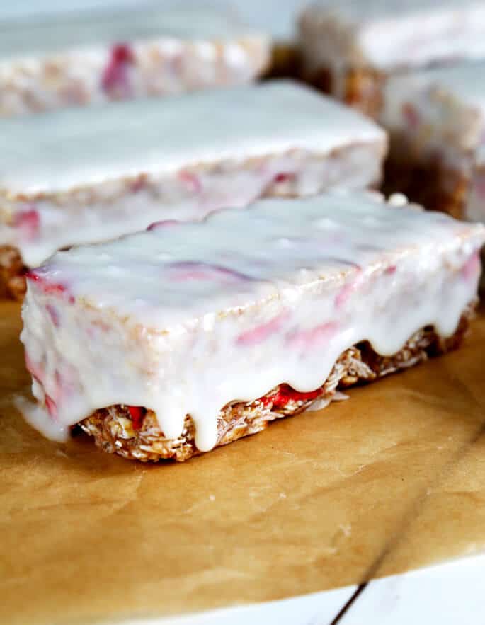 A close up of strawberry granola bars covered in granola