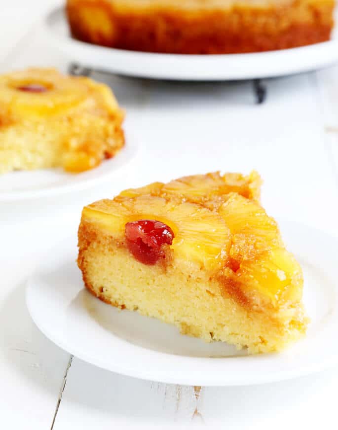 A piece of pineapple upside down cake on a white plate