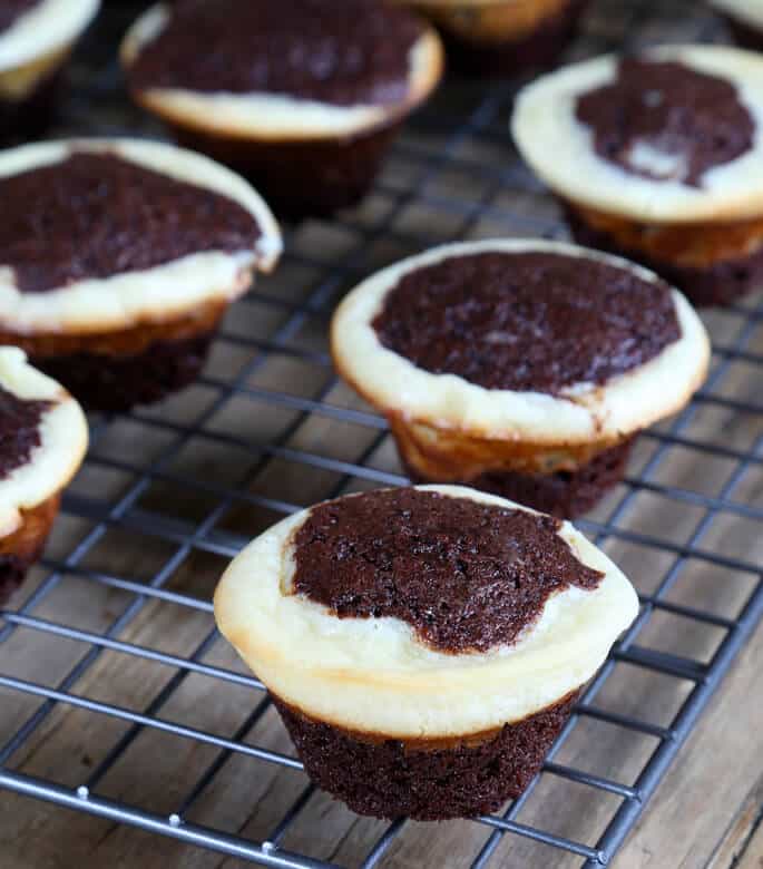 Cheesecake brownie bites on a black tray