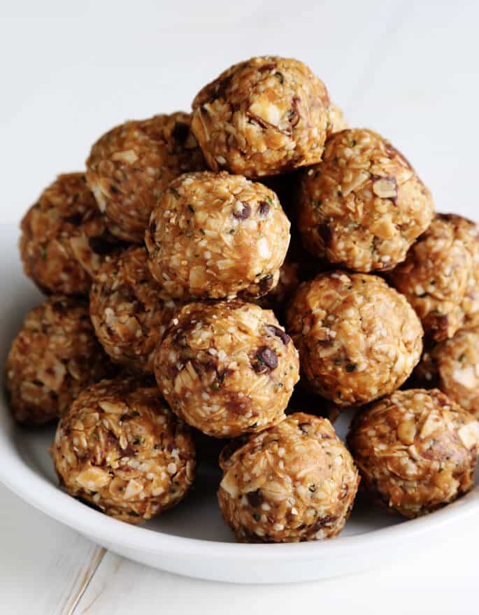 a pile of protein balls made with oats and chocolate chips on a small white plate