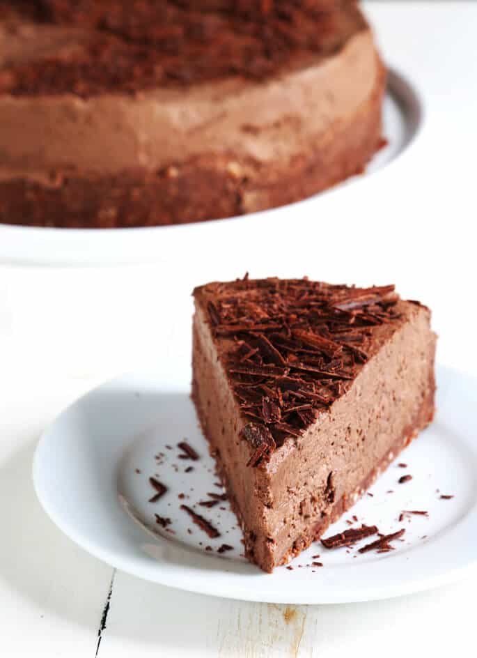 A piece of no bake chocolate cheesecake with chocolate shavings on top