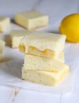 A stack of 3 lemon brownies on white surface