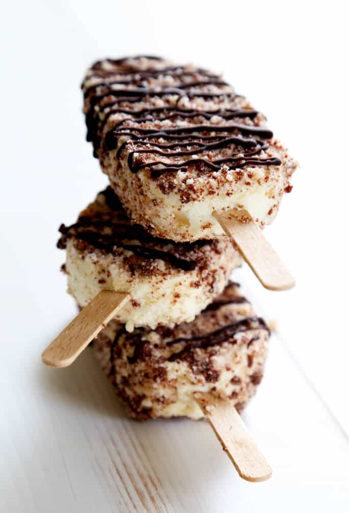 Stack of chocolate eclair ice cream bars on white surface