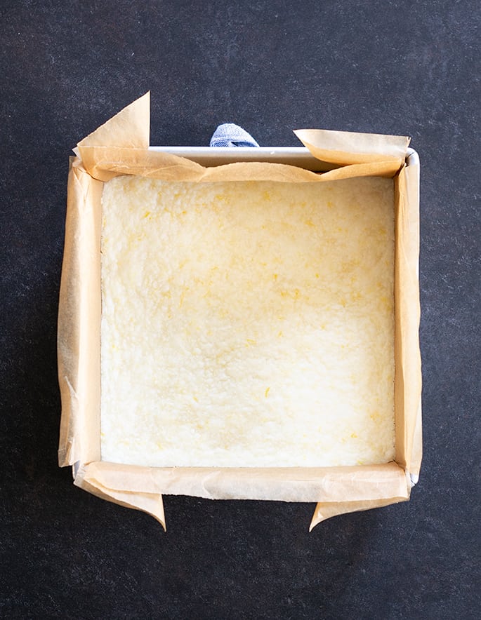 Overhead image of baked lemon crust in a square pan