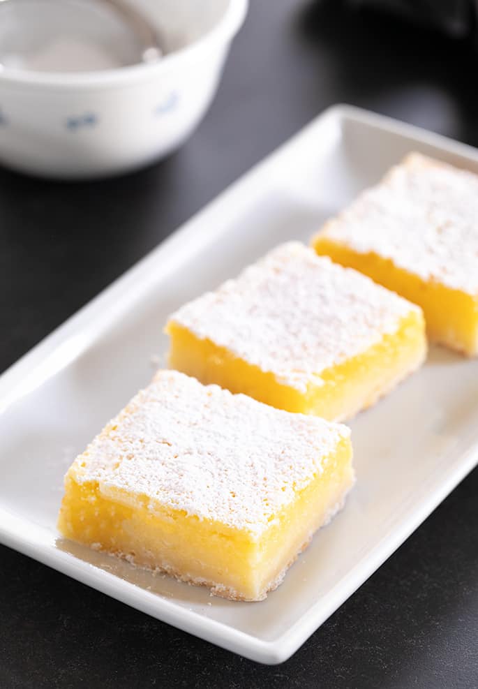 A simple lemony shortbread crust with a tart, refreshing lemon custard, these gluten free lemon bars are so easy to make.