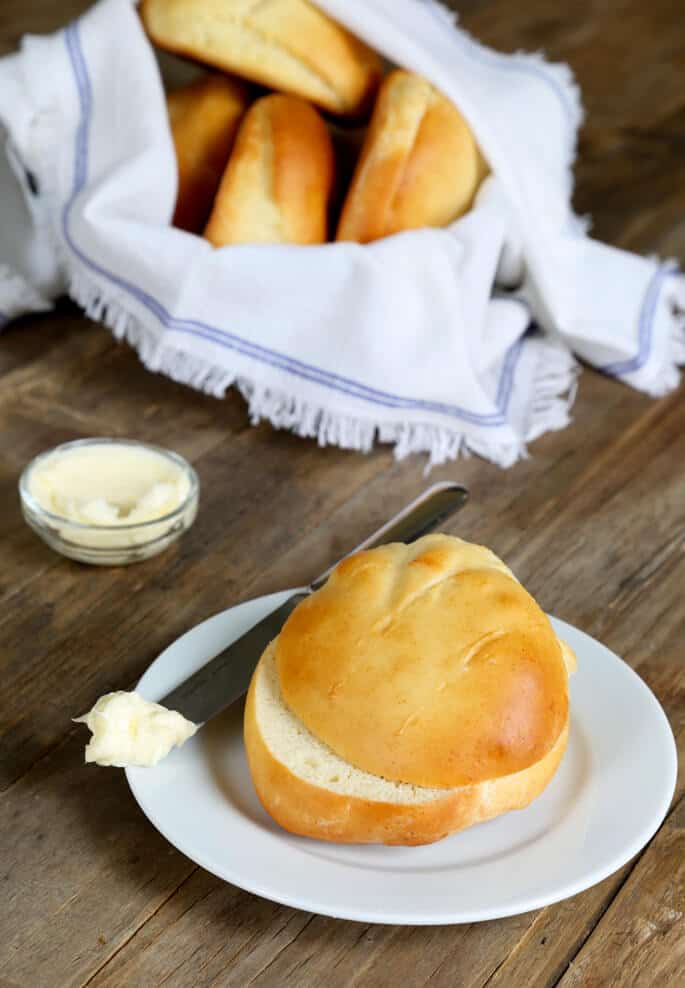 Cottage cheese roll and knife on white plate 