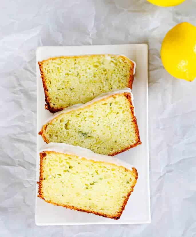 Overhead view of lemon zucchini bread on a white plate