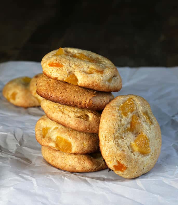 Stack of peach pie cookies on a white surface 