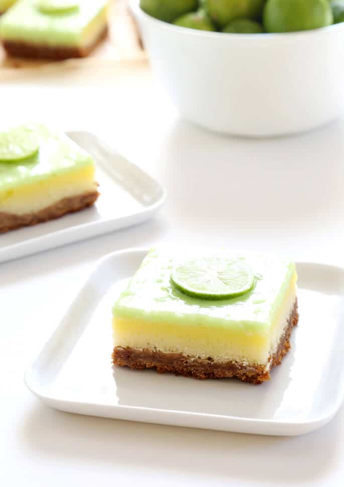 A close up of a key lime pie bar on a white plate